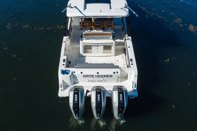 Slide: The Image of 2024 Boston Whaler 42 OUTRAGE boat with triple 600hp engines on water. - 23