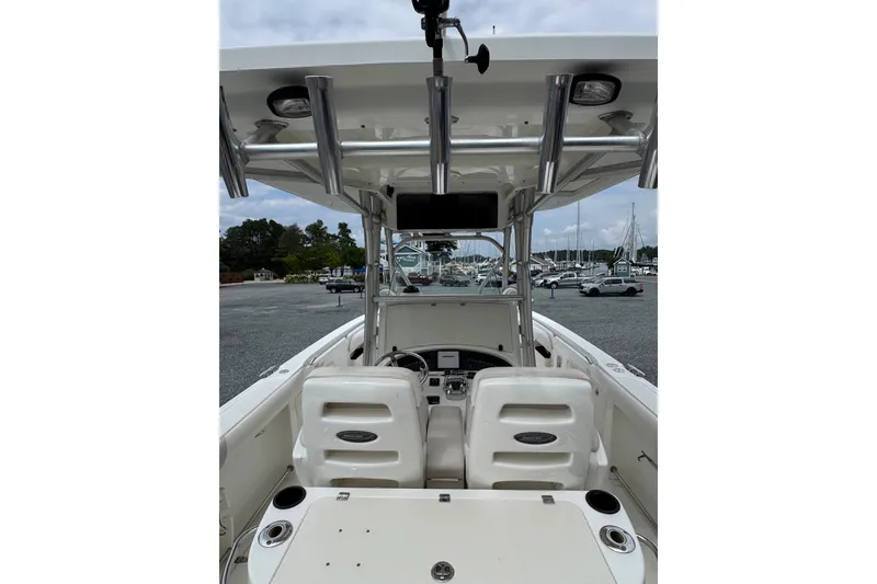 Slide: The Image of 2005 Boston Whaler Outrage 320 boat interior with helm and seating, docked at marina. - 3