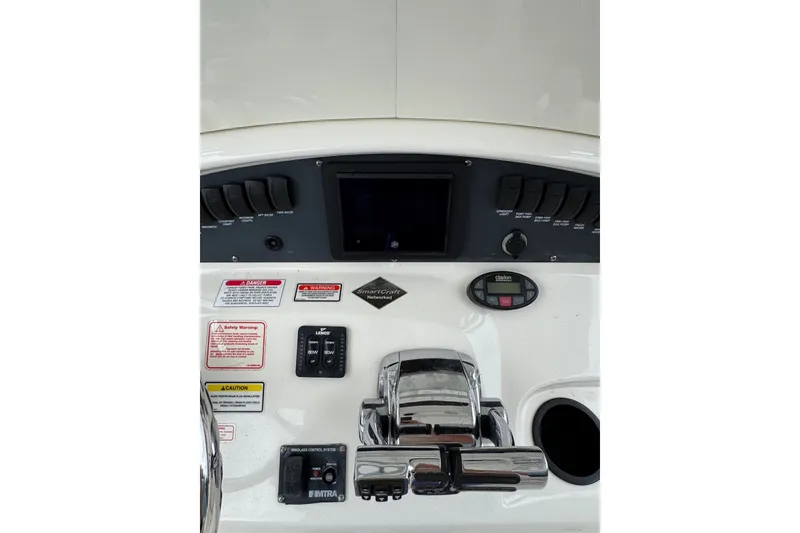Slide: The Image of Control panel of a 2005 Boston Whaler Outrage 320 boat with various switches and gauges. - 17