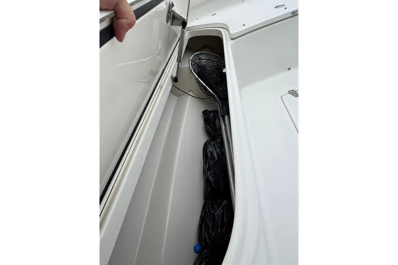 Slide: The Image of Storage compartment of a 2005 Boston Whaler Outrage 320 boat, containing fishing gear. - 10
