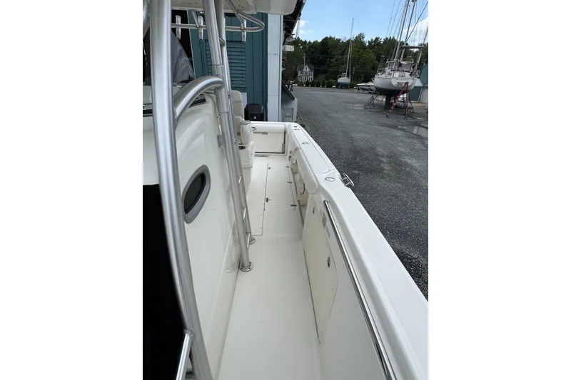 Slide: The Image of 2005 Boston Whaler Outrage 320 boat deck, featuring sleek design and sturdy railings. - 13
