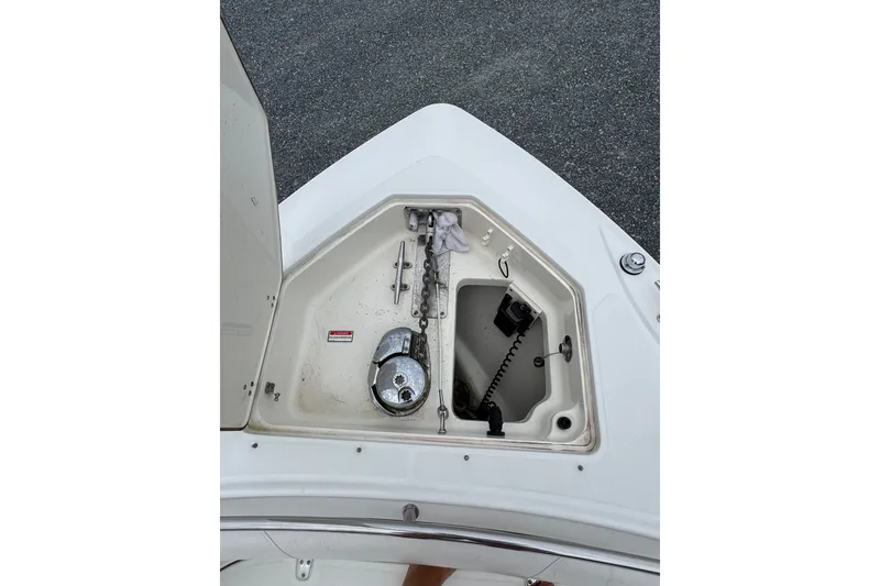 Slide: The Image of Anchor compartment of 2005 Boston Whaler Outrage 320 boat, featuring chain and winch. - 7