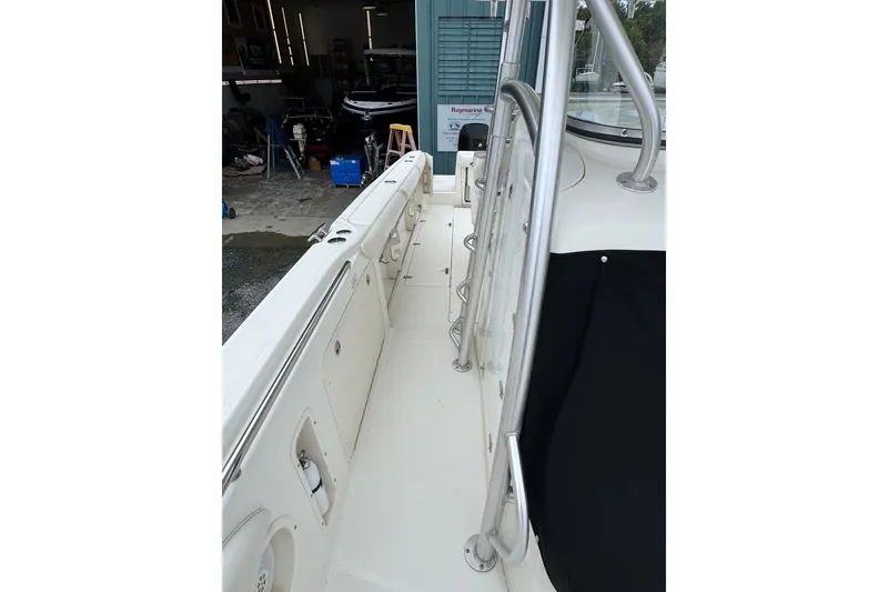 Slide: The Image of 2005 Boston Whaler Outrage 320 boat interior with stainless steel railings and storage compartments. - 12