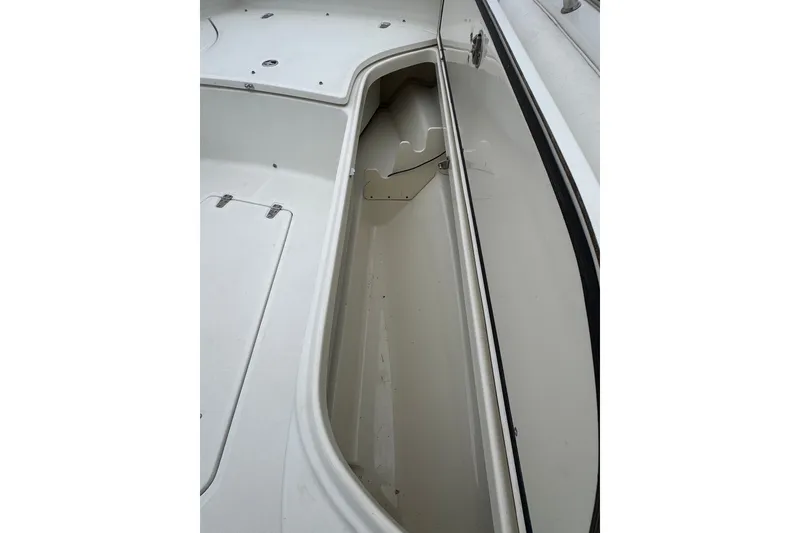 Slide: The Image of Storage compartment on a 2005 Boston Whaler Outrage 320 boat deck. - 11