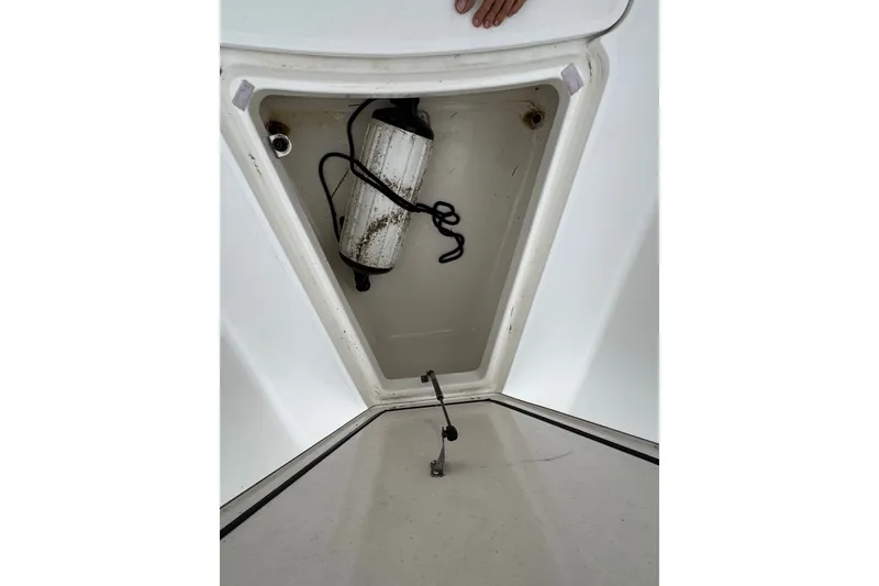 Slide: The Image of Storage compartment of a 2005 Boston Whaler Outrage 320 boat, featuring a coiled rope. - 9
