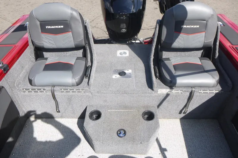 Slide: The Image of 2021 Tracker Targa V-19 Combo boat interior with two gray seats and cup holders. - 14