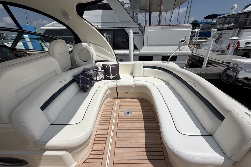 Slide: The Image of Luxurious 2004 Sea Ray 390 Sundancer yacht with elegant white seating and nautical-themed cushions. - 6