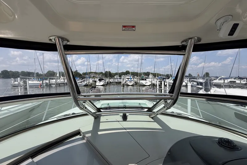 Slide: The Image of 2004 Sea Ray 390 Sundancer yacht interior view at marina with boats and clear sky. - 12