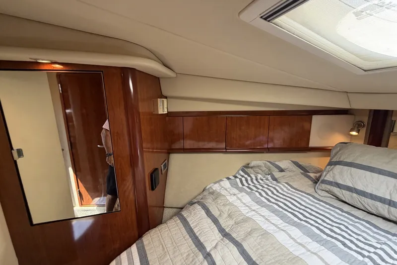 Slide: The Image of Luxurious cabin interior of 2004 Sea Ray 390 Sundancer yacht with wood paneling and bedding. - 37