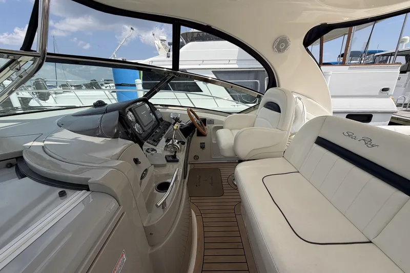 Slide: The Image of 2004 Sea Ray 390 Sundancer cockpit with luxurious seating and modern controls. - 11