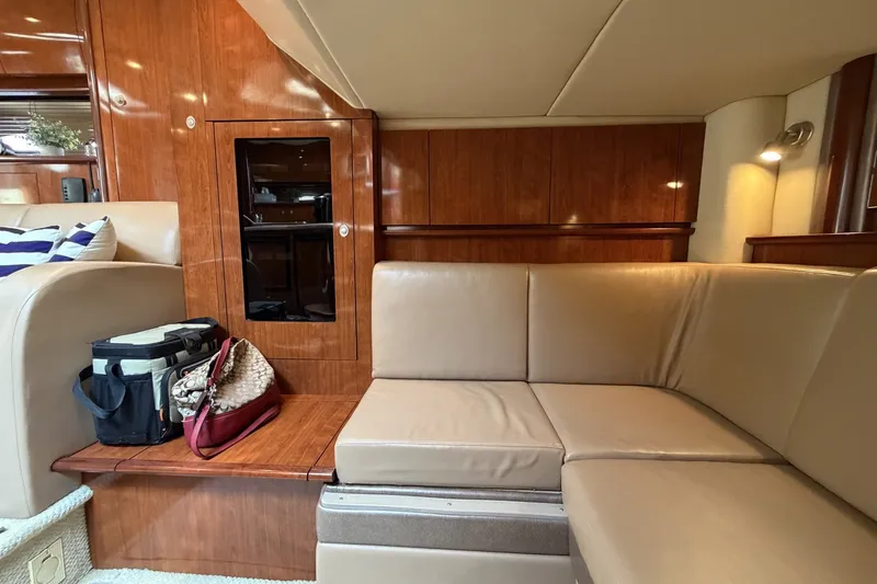 Slide: The Image of Luxurious interior of 2004 Sea Ray 390 Sundancer yacht with leather seating and wooden cabinetry. - 34