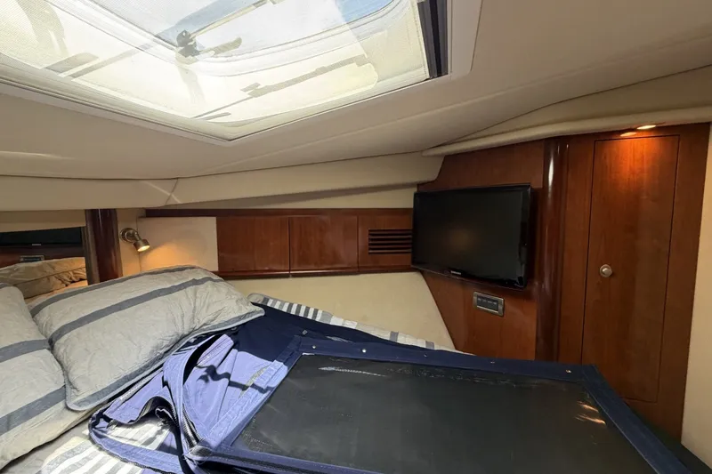 Slide: The Image of Luxurious cabin interior of 2004 Sea Ray 390 Sundancer with skylight and TV. - 36