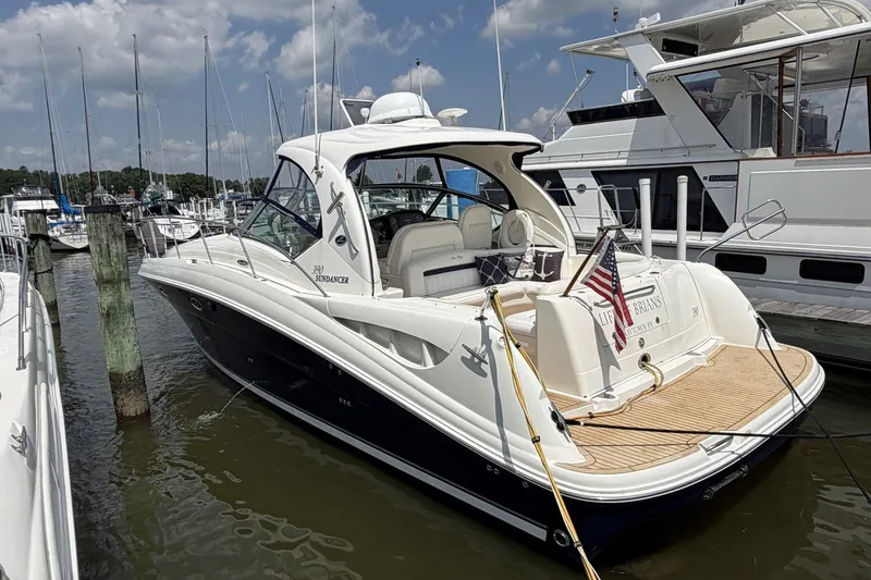 Slide: The Image of 2004 Sea Ray 390 Sundancer yacht docked at marina under blue sky. - 4