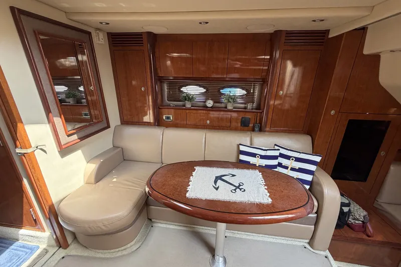 Slide: The Image of Luxurious 2004 Sea Ray 390 Sundancer yacht interior with elegant seating and nautical decor. - 26