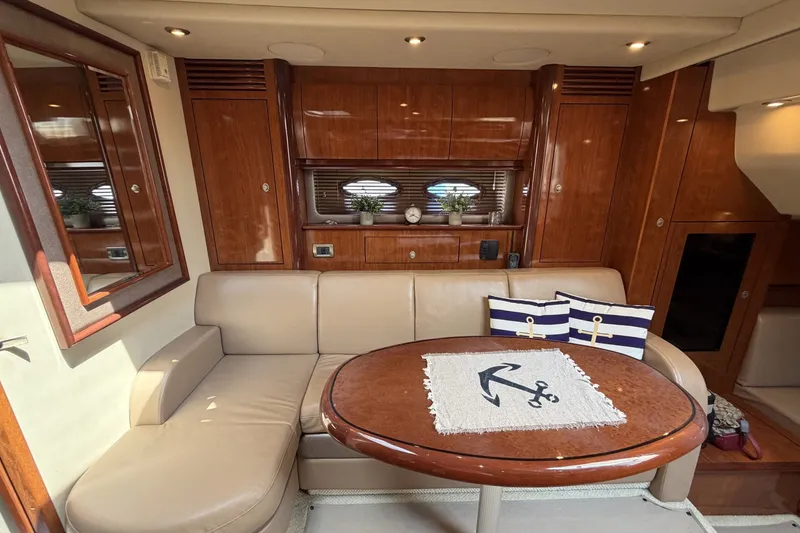 Slide: The Image of Luxurious 2004 Sea Ray 390 Sundancer yacht interior with elegant wood finishes and cozy seating. - 27