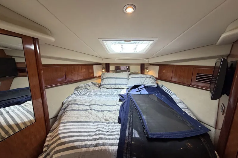 Slide: The Image of Luxurious cabin interior of 2004 Sea Ray 390 Sundancer yacht with cozy bedding. - 35