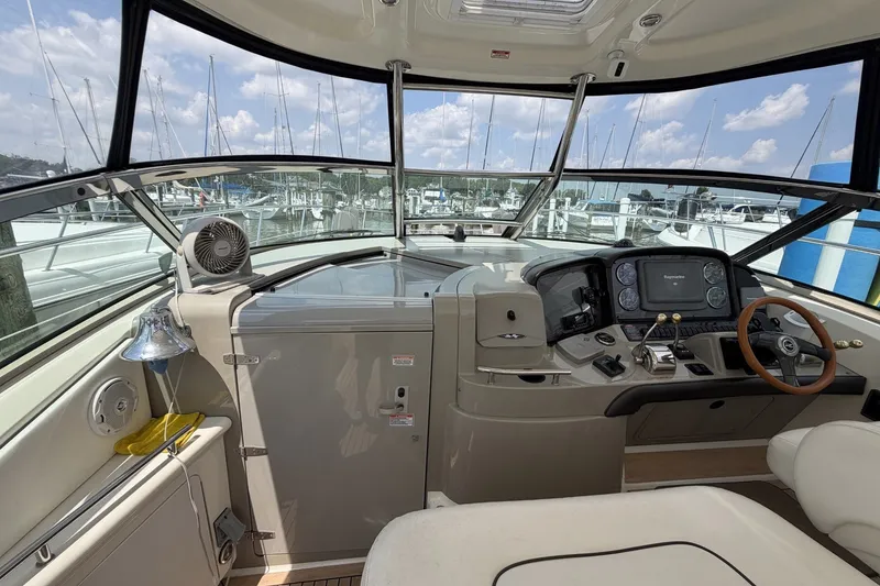 Slide: The Image of 2004 Sea Ray 390 Sundancer helm with modern controls and marina view. - 13