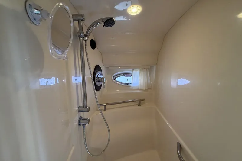 Slide: The Image of Shower area in 2004 Sea Ray 390 Sundancer yacht with handheld showerhead and porthole. - 40