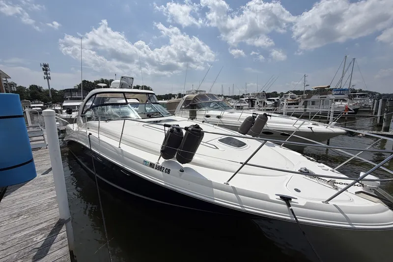 The Image of 2004 Sea Ray 390 Sundancer yacht docked at marina under cloudy sky. - 1