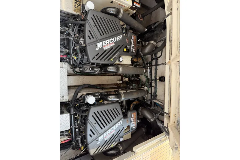 Slide: The Image of Engine compartment of a 2004 Sea Ray 390 Sundancer with twin Mercury engines. - 42