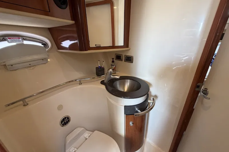 Slide: The Image of Bathroom interior of 2004 Sea Ray 390 Sundancer yacht, featuring sink and toilet. - 39