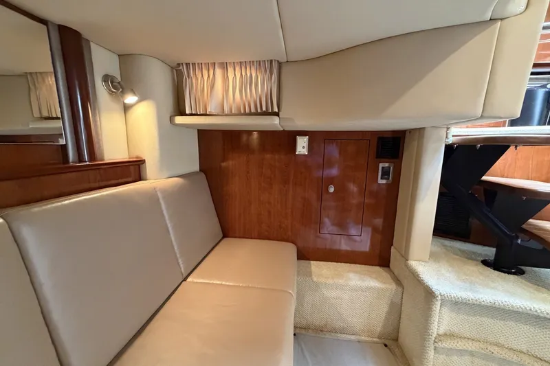 Slide: The Image of Interior of 2004 Sea Ray 390 Sundancer yacht with beige seating and wooden accents. - 33