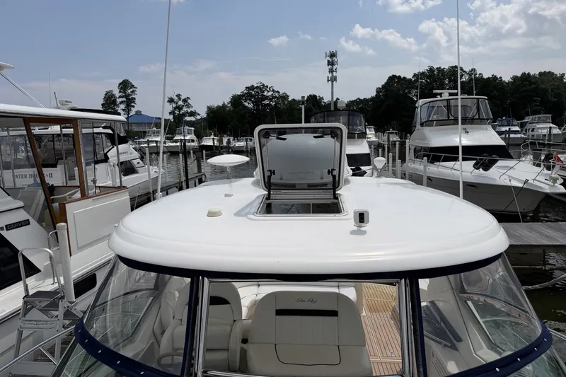 Slide: The Image of 2004 Sea Ray 390 Sundancer yacht docked at marina, surrounded by other boats. - 22
