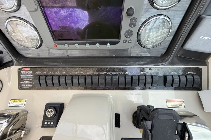 Slide: The Image of Control panel of a 2004 Sea Ray 390 Sundancer boat with gauges and switches. - 17