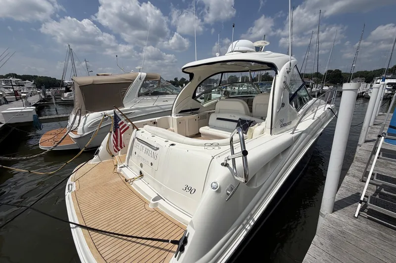 Slide: The Image of 2004 Sea Ray 390 Sundancer yacht docked at marina under cloudy sky. - 2