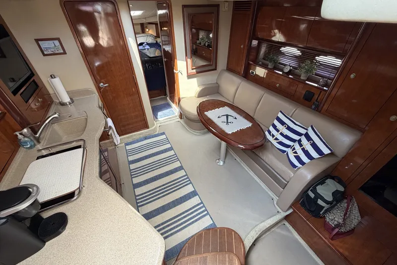 Slide: The Image of Interior of 2004 Sea Ray 390 Sundancer yacht with cozy seating and nautical decor. - 25