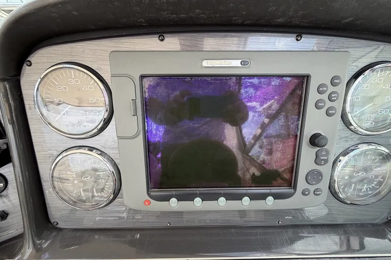 Slide: The Image of Dashboard of a 2004 Sea Ray 390 Sundancer with gauges and navigation display. - 20