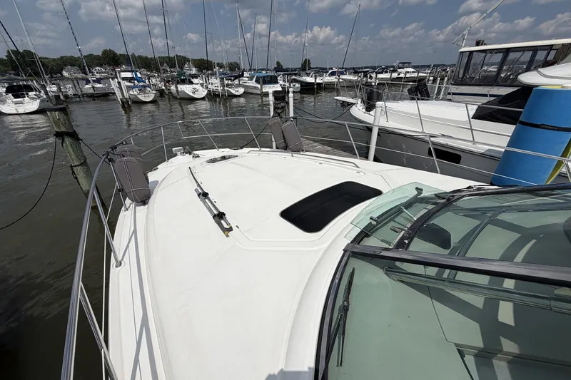 Slide: The Image of 2004 Sea Ray 390 Sundancer yacht docked at a marina with other boats. - 21