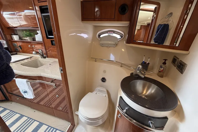Slide: The Image of Luxurious 2004 Sea Ray 390 Sundancer yacht bathroom with modern amenities and elegant wood finishes. - 38
