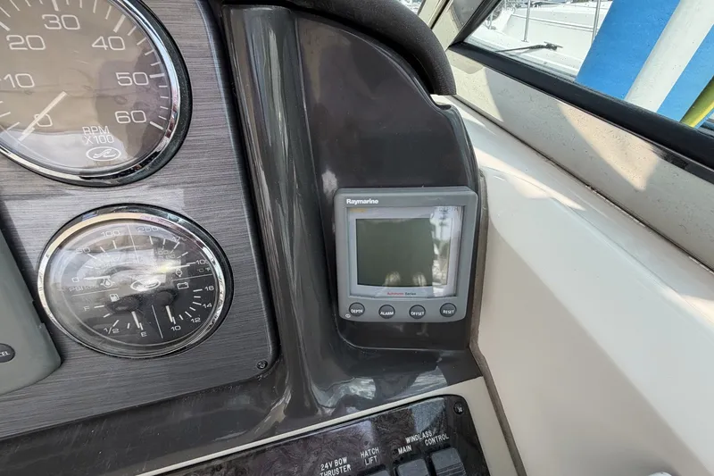 Slide: The Image of Dashboard of 2004 Sea Ray 390 Sundancer with gauges and Raymarine display. - 16