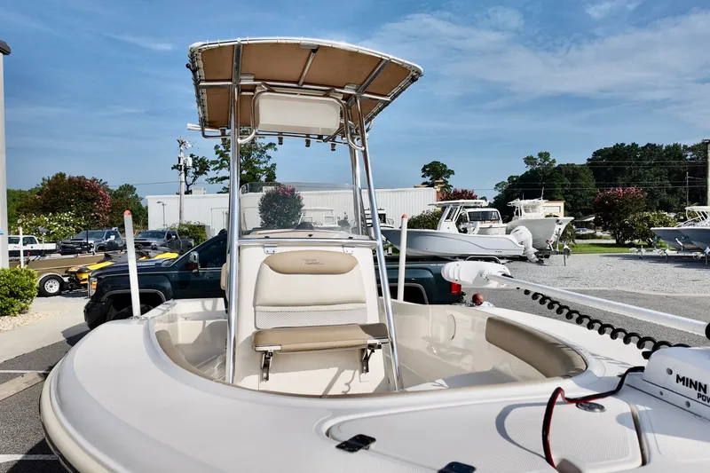 Slide: The Image of 2020 Pioneer 180 Sportfish boat with T-top and seating, displayed outdoors. - 5