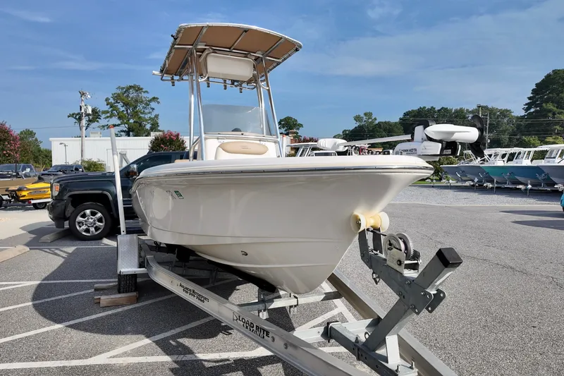 Slide: The Image of 2020 Pioneer 180 Sportfish boat on trailer in parking lot, clear sky background. - 2