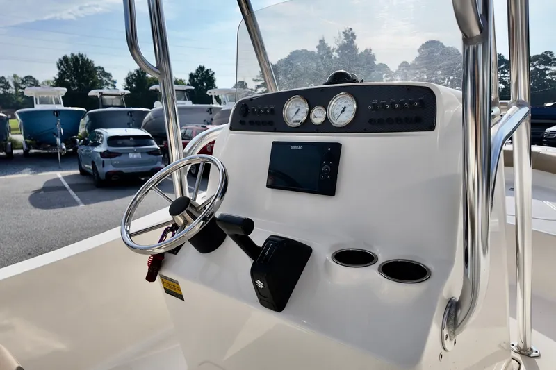 Slide: The Image of Console of a 2020 Pioneer 180 Sportfish boat with steering wheel and gauges. - 8