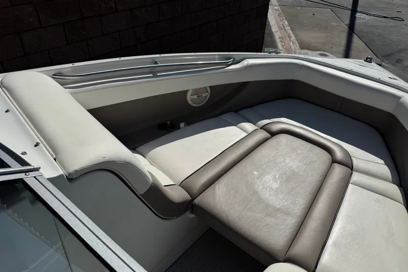 Slide: The Image of Interior seating of a 2001 Cobalt 232 boat, featuring beige and gray upholstery. - 13