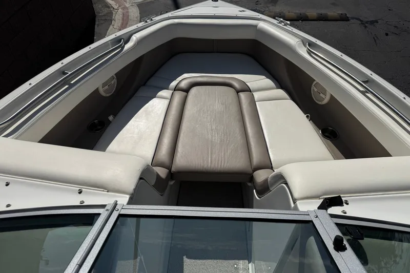Slide: The Image of Interior of a 2001 Cobalt 232 boat with cushioned seating and cup holders. - 12