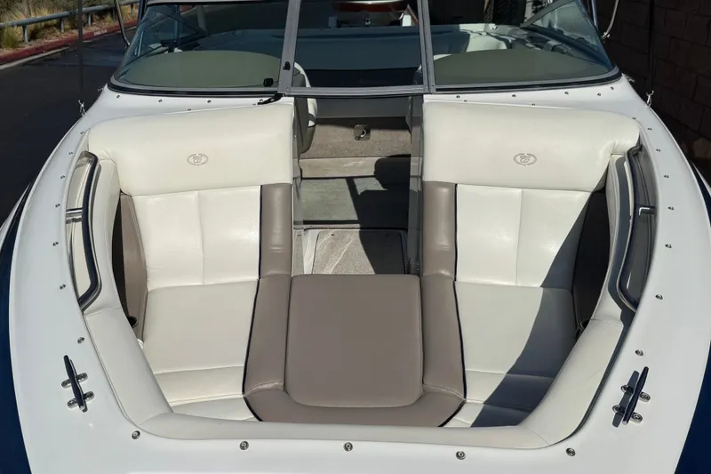 Slide: The Image of 2001 Cobalt 232 boat interior with white and gray seating, open bow design. - 9