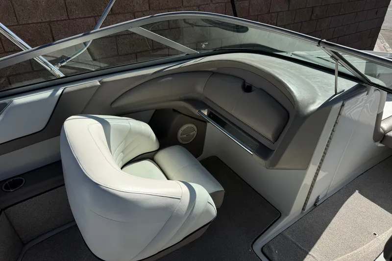 Slide: The Image of Interior of a 2001 Cobalt 232 boat with white seating and dashboard. - 25