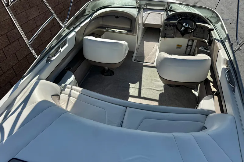 Slide: The Image of Interior of a 2001 Cobalt 232 boat with white seating and steering console. - 8