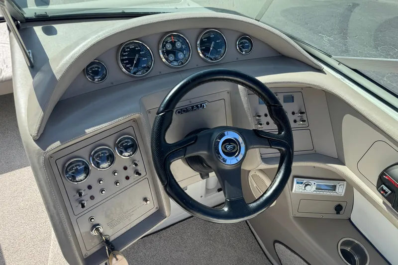 Slide: The Image of Steering console of a 2001 Cobalt 232 boat with gauges and controls. - 30