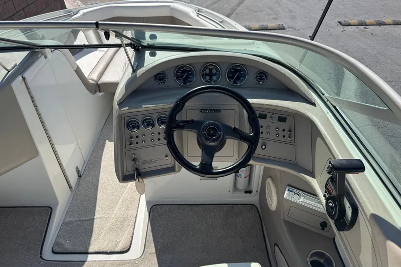 Slide: The Image of 2001 Cobalt 232 boat cockpit with steering wheel and control panel. - 29