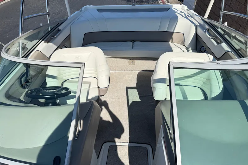Slide: The Image of Interior of a 2001 Cobalt 232 boat with white seating and steering wheel. - 18