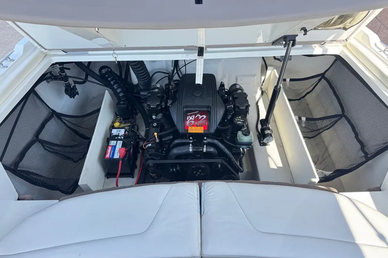 Slide: The Image of Open engine compartment of a 2001 Cobalt 232 boat, showcasing the engine and battery. - 20