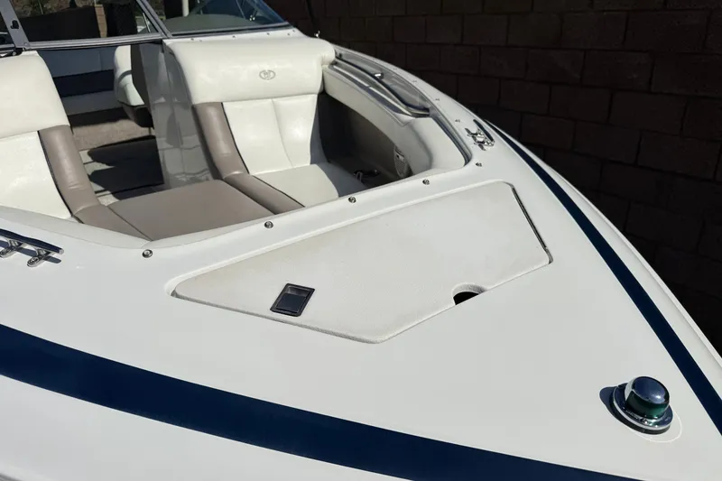 Slide: The Image of 2001 Cobalt 232 boat interior with white and beige seating, sleek design. - 10