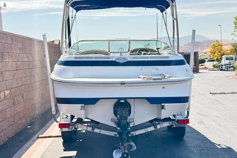 Slide: The Image of 2001 Cobalt 232 boat on trailer, rear view, parked outdoors. - 4