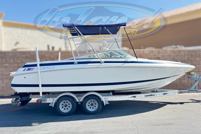 The Image of 2001 Cobalt 232 boat on trailer, featuring sleek design and blue accents. - 0