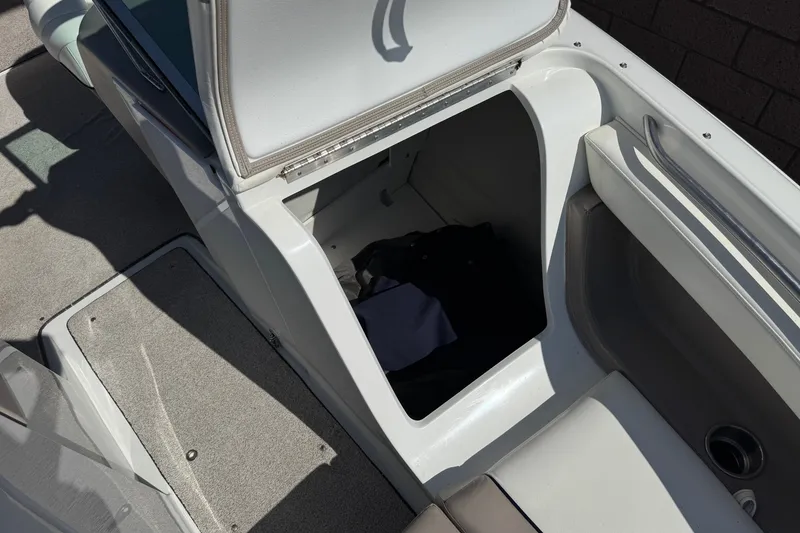 Slide: The Image of Open storage compartment on a 2001 Cobalt 232 boat, showing interior space. - 15